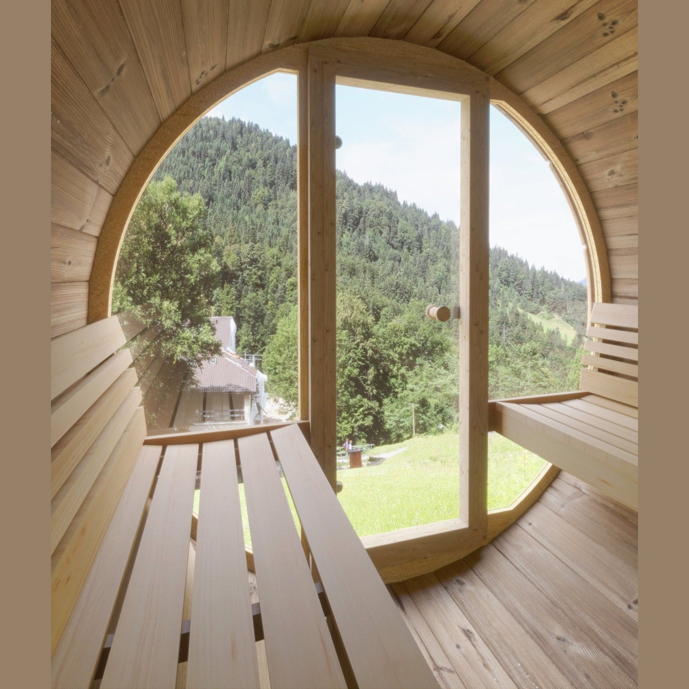 Wooden sauna with large round window overlooking a green landscape